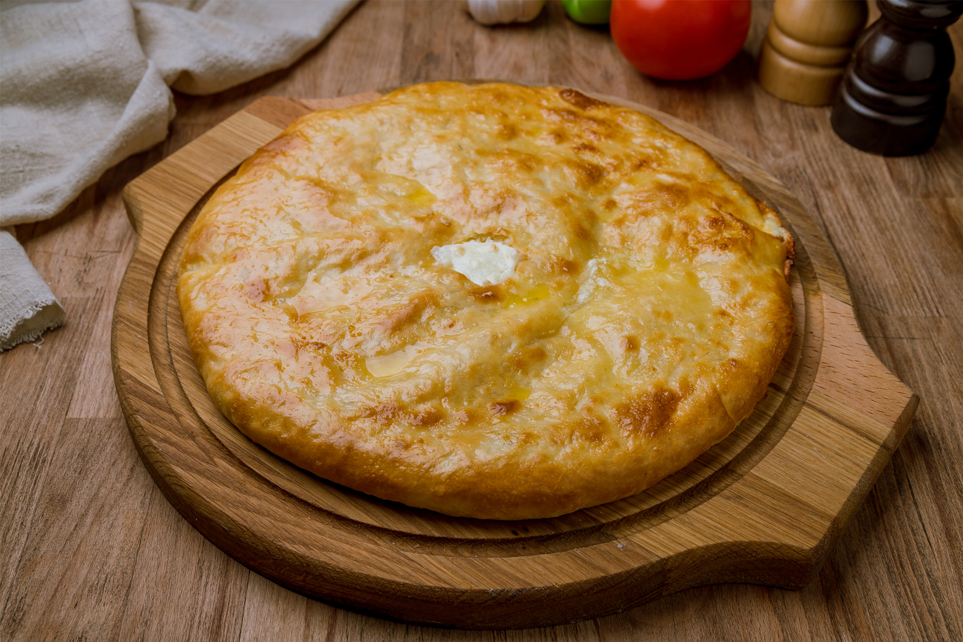 Ossetian pie with cheese on wooden table